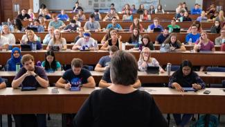 A faculty member speaks to a class.