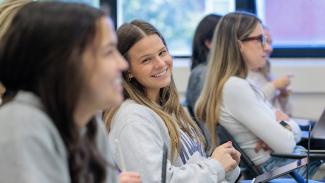 Students smile in a Family Sciences class.