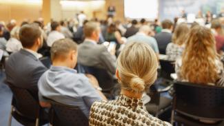 An audience listens to a speaker.