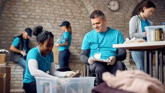 Volunteers sort clothing donations.